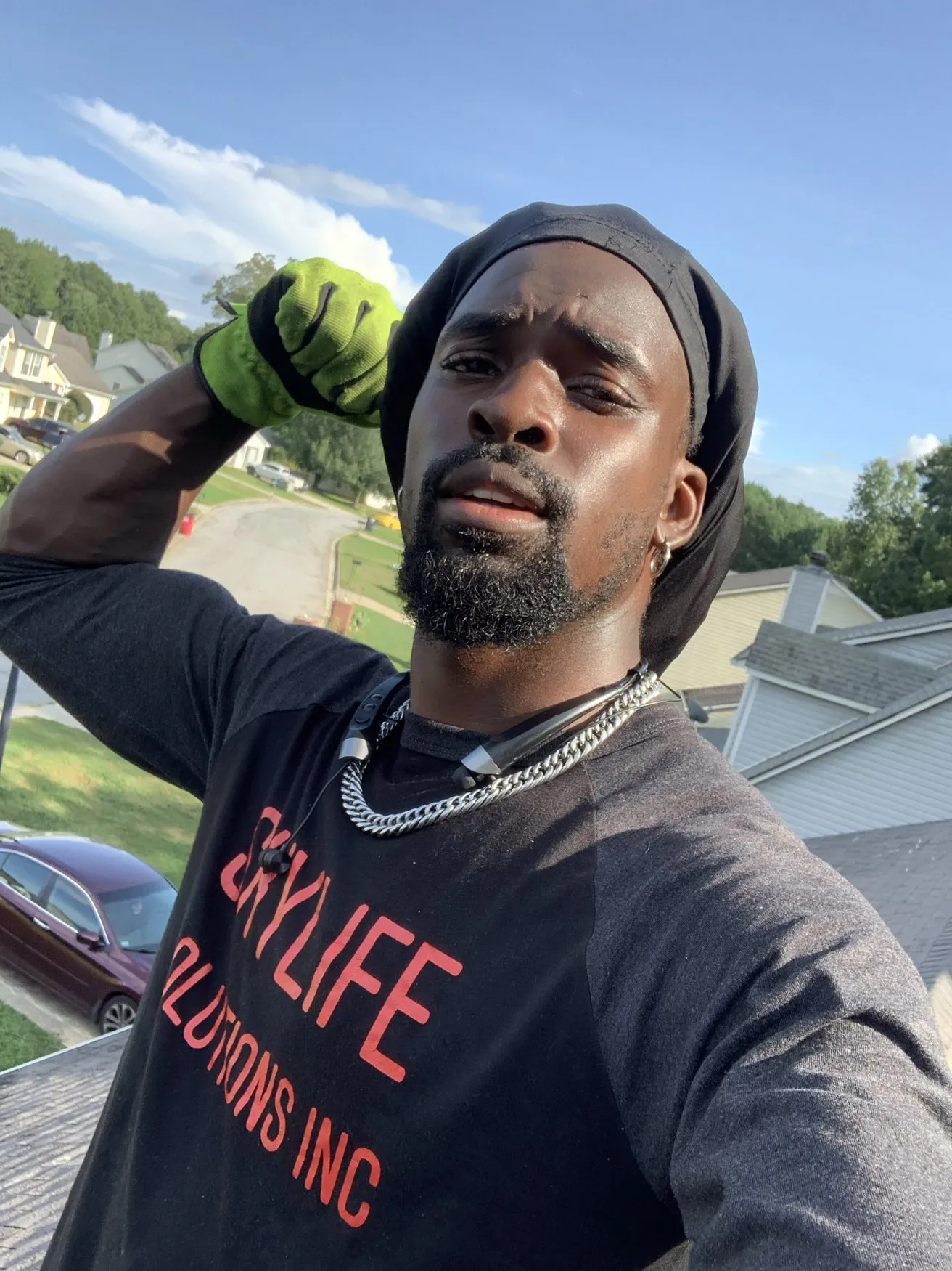 The owner on a rooftop in a Skylife Solutions shirt